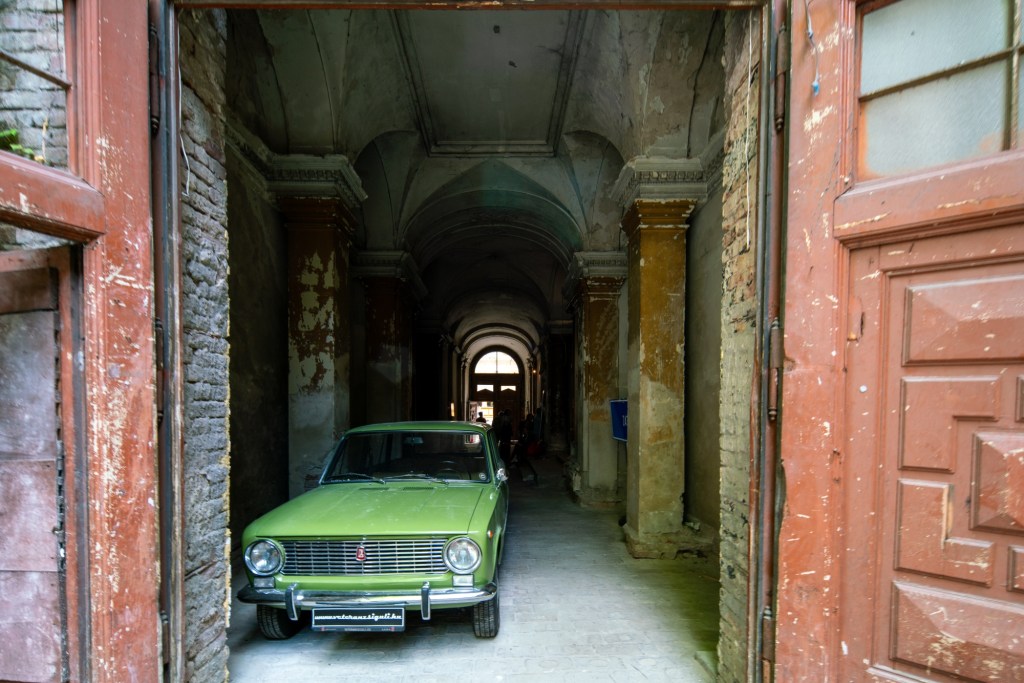 A green lada in the interior of an abandoned mansion in Budapest where the famous racehorse Kincsem used to live.
