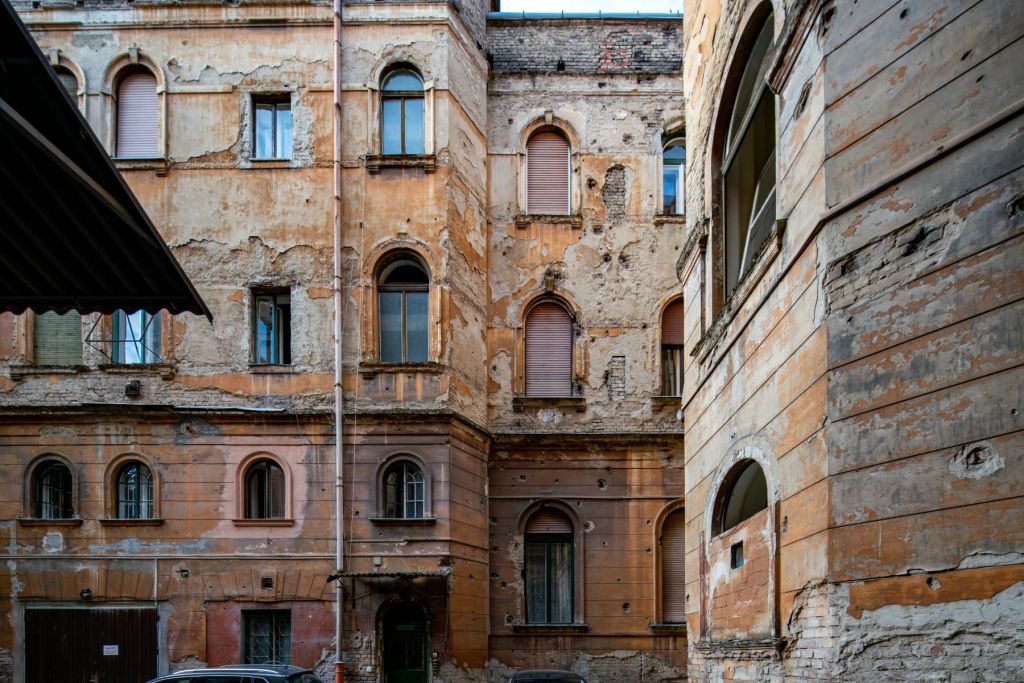 Detail of a courtyard with bullet riddled walls in the 8th district of Budapest