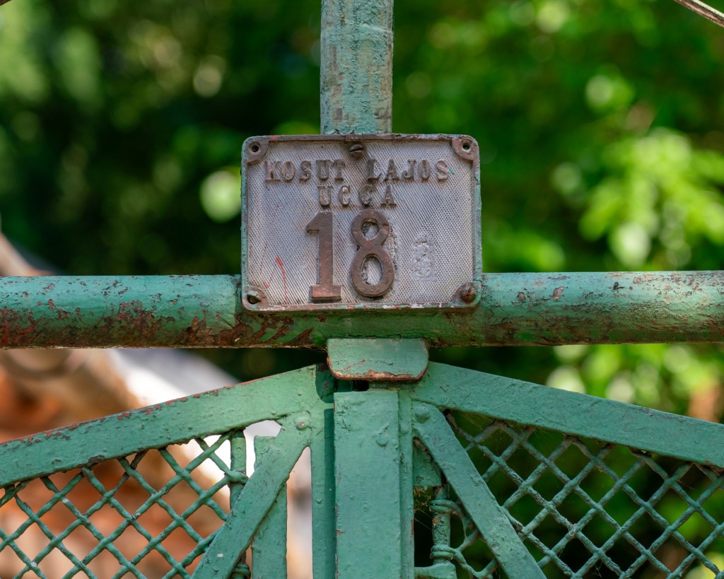 Old house number plate in Csillaghegy, Budapest. Lajos Kossuth's name is misspelled and "street", in Hungarian "utca", is written here "ucca" which is an old spelling not used since the 1940s.