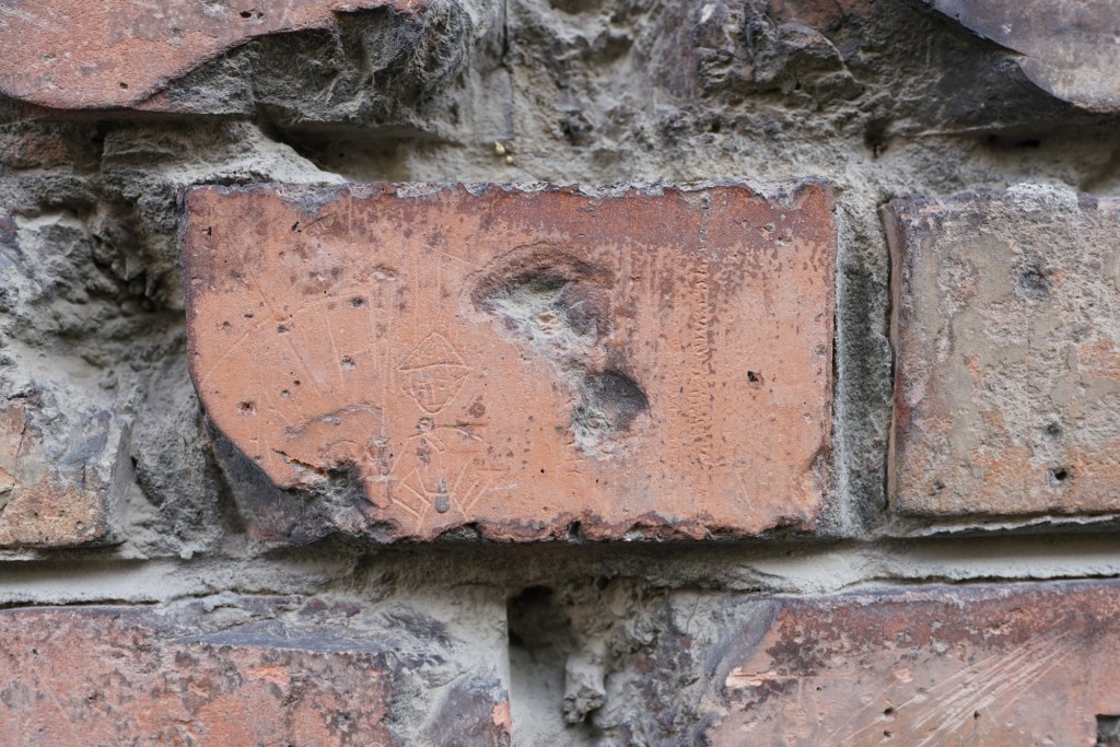 A small man carved into a brick on Logodi utca